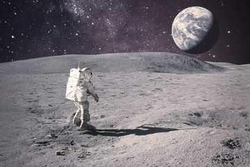 Wall Mural - astronaut on rock surface with space background. elements of this image furnished by nasa