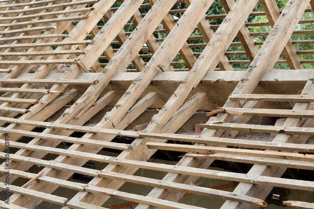 Broken rafters on a failed spreading roof Stock Photo | Adobe Stock