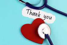 Medical Stethoscope, Healthy Red Heart And The Inscription Thank You On A Blue Background
