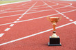 © weerapat1003 - A golden trophy on running track / Competition for success concept