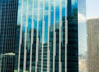 Modern office buildings with glass facade reflecting their surroundings 