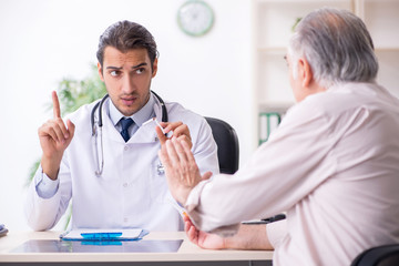 Sticker - Young male doctor and old patient in antismoking concept