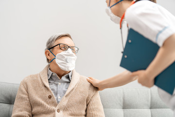 Doctor and senior man wearing facemasks