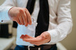 © Dragica - A young man pours a hand sanitizer into his hand. Protection from COVID - 19