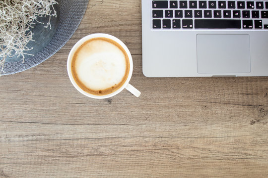Coffee mug with laptop on a rustic table / Homeoffice workplace template / easy to customize