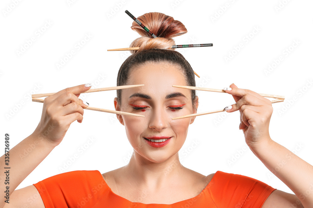 Beautiful woman with chopsticks on white background