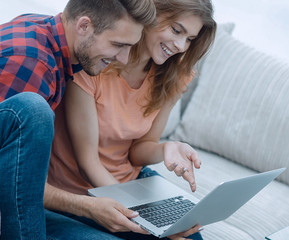 Poster - young couple watching videos on laptop