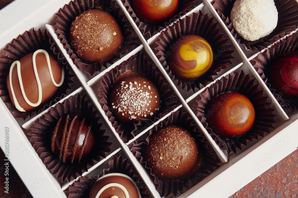 Box with delicious chocolate candies, closeup