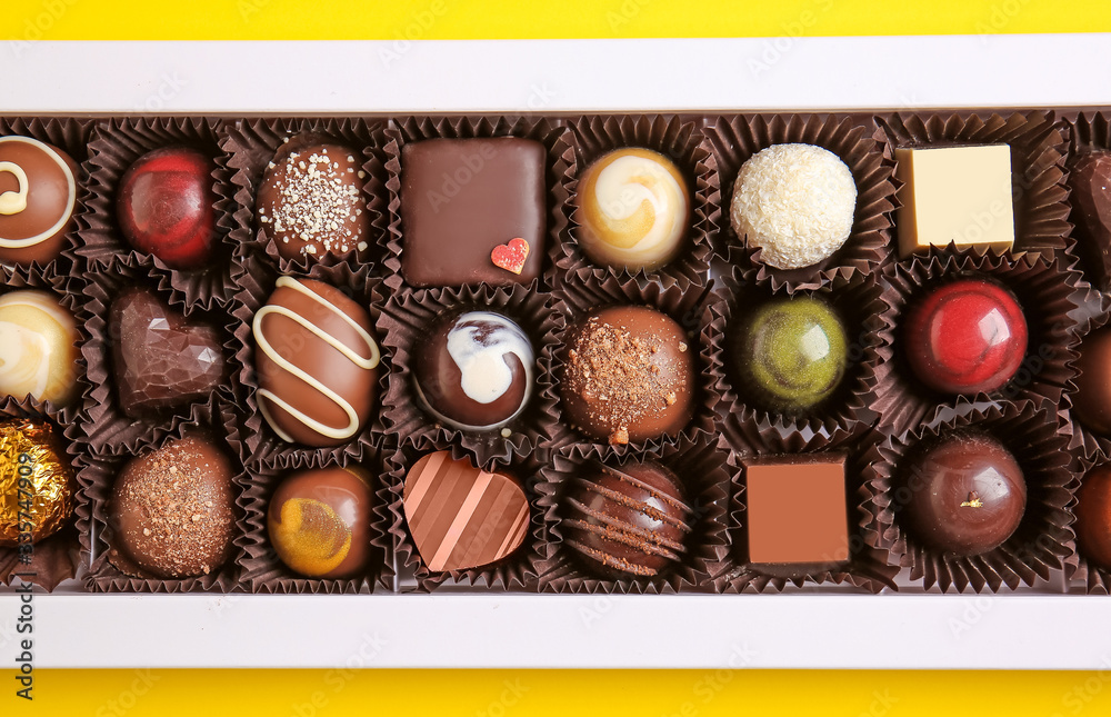Box with delicious chocolate candies, closeup
