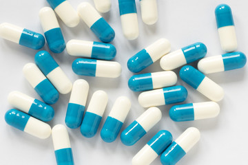 Wall Mural - blue-white pills on a plain background