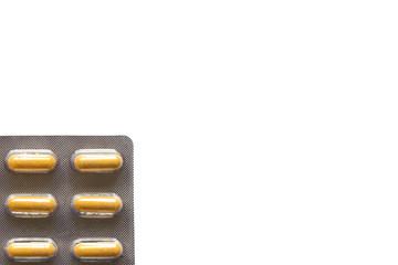 Wall Mural - yellow pills in a blister on a plain background