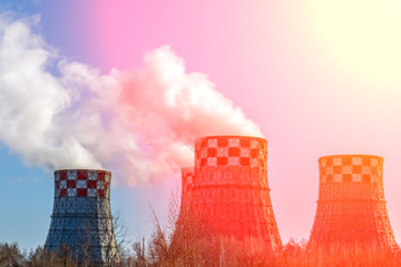 smoke pipe against clear blue sky. The smoke from chimney of a power station. Smoking a pipe of heating plants supplying heat to the city. Smoking chimneys of the factory