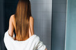 Rear view of a beautiful woman with long straight hair at spa