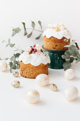 Wall Mural - Glazed easter cake decorated with flowers on white textured background. Happy Easter Holidays