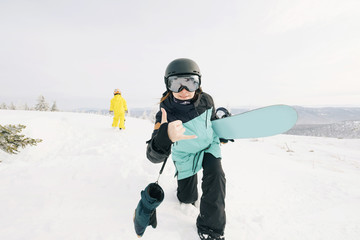 Family of snowboarders playing and have fun in snow on mountain top. Sunny holiday in ski resort