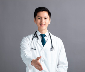 Wall Mural - Portrait of male asian young doctor  with handshake gesture