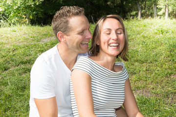 Wall Mural - Happy laughing lovely young couple in love spending time outdoors summer day