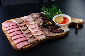 Wall Mural - Set mix jerky, sausage, salami and bacon served on a wooden board