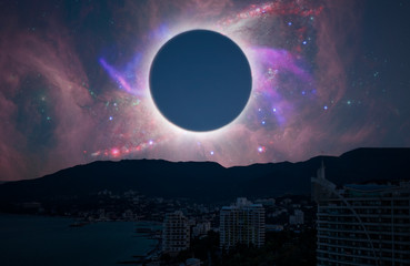Wall Mural - the solar eclipse in the sky over the city, elements of this image is furnished by nasa