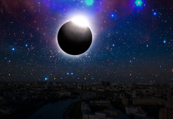 Wall Mural - the solar eclipse in the sky over the city, elements of this image is furnished by nasa