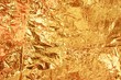 Closeup shot of a crumpled golden candy wrapper