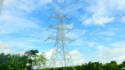 high voltage power lines on green field