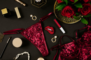 Sexy seductive lingerie with golden woman accessories on black background. Female accessories for seduction and date concept. Flat lay, overhead view