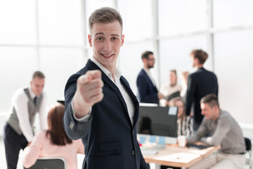 confident young business man pointing at you