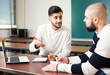 © JackF - Guys working on student project at desk