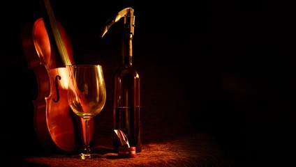 Poster - Closeup shot of wine glass, wine opener, violin and a bottle