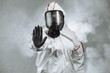 © alfa27 - keep the distance, stop to coronavirus. disinfector male in gas-mask and protective suit disinfect contaminated areas full of bacterias. quarantine time