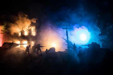 War Concept. Military silhouettes fighting scene on war fog sky background, World War Soldiers Silhouette Below Cloudy Skyline At night.