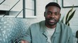© Sofiia - Portrait of attractive young african-american man vlogger speaking looking at camera smile happy recording new vlog blogger broadcast media business webcam businessman distance education