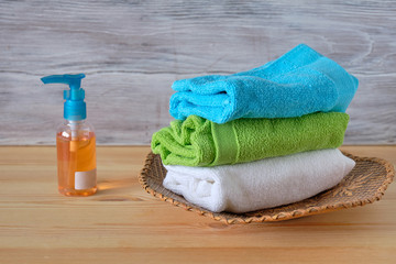 Multicolored towels on a wooden background lying next to each other