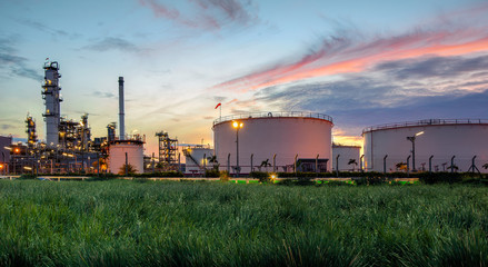 Oil and gas industry, oil refinery industry, refinery form factories, oil storage tanks and steel pipes with sunset background