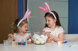 © erainbow - Girls paint easter eggs