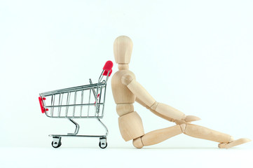 wooden mannequin and shopping cart, online shopping and delivery concept