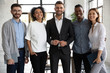 © fizkes - Portrait of standing in row smiling diverse team looking at camera. Happy multiethnic corporate staff, young specialists, company representatives, bank workers photo shoot, HR agency recruitments.
