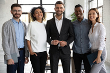 Portrait Of Standing In Row Smiling Diverse Team Looking At Camera. Happy Multiethnic Corporate Staff, Young Specialists, Company Representatives, Bank Workers Photo Shoot, HR Agency Recruitments.