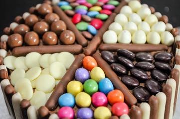 Sweets confectionary decorating the top of a birthday cake.