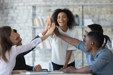 Excited Successful African American Businesswoman With Multiracial Business People Giving High Five, Celebrating Win. Happy Employees Team Engaged In Team Building Activity At Corporate Meeting.