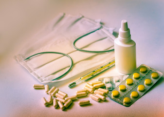 Pills and thermometer. Photograph of medicines. Face masks. Respirator.