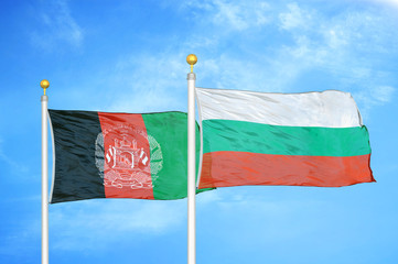 Afghanistan and Bulgaria   two flags on flagpoles and blue cloudy sky