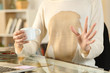 © PheelingsMedia - Woman hands with spilled coffee over her shirt