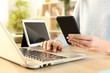 © PheelingsMedia - Woman hands using multiple devices at home