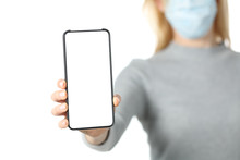 Woman With Mask Showing Blank Phone Screen Isolated On White