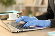 © PheelingsMedia - Freelance hands with defective latex gloves working
