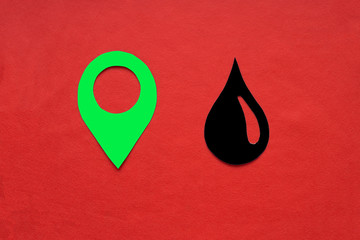 Fototapete - The geolocation sign is green, with a drop of oil on a red background. Oil and petroleum products market.