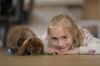 © muro - little child playing with a rabbit