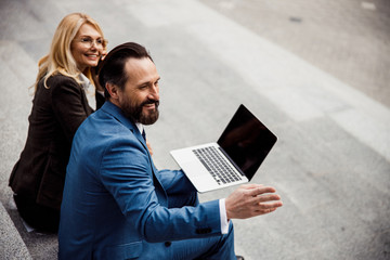 joyous caucasian woman and her high-spirited colleague